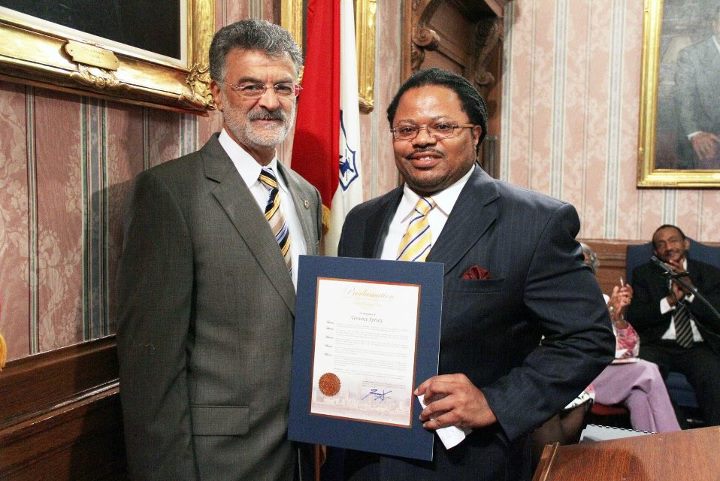 Terrence Spivey receiving a certificate from Cleveland mayor Frank G. Jackson